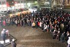 Große Menschenmenge auf einem Platz bei Nacht